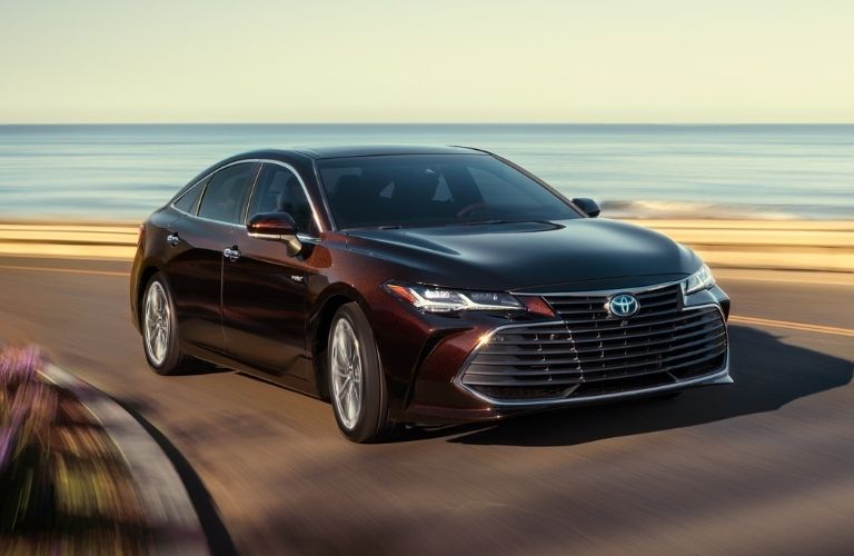 2021 Toyota Avalon Hybrid driving on coastal road