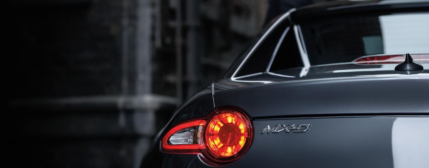 A close up shows the driver side taillight on a silver 2019 Mazda MX-5 Miata RF.