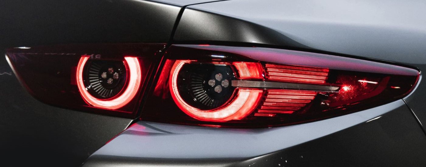 A close up shows the passenger side taillight on a grey 2019 Mazda3.