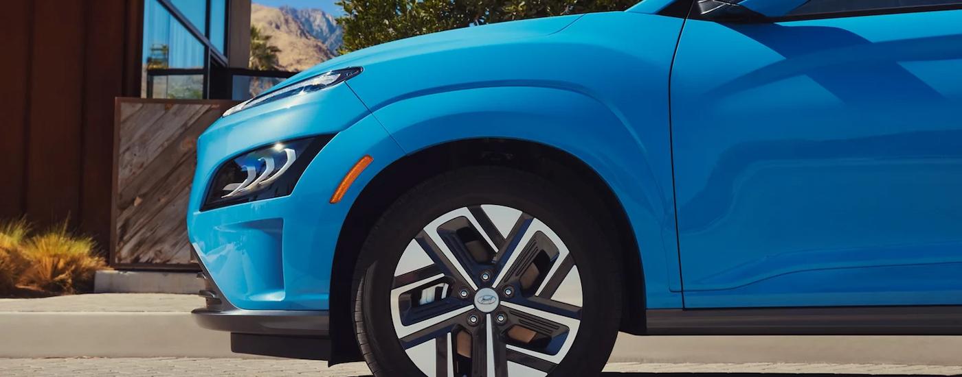 A close up of the side of a blue 2023 Hyundai Kona is shown.