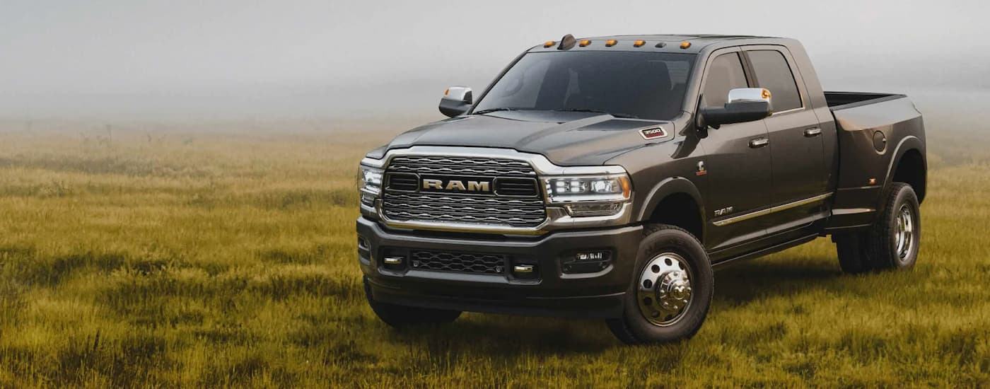 A popular Ram truck, a grey 2022 Ram 3500, is shown parked in a field.