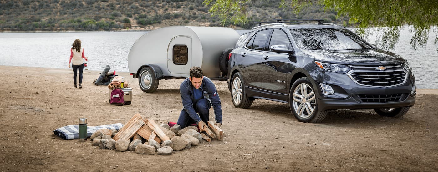 A grey 2020 Chevy Equinox is shown at a campsite.