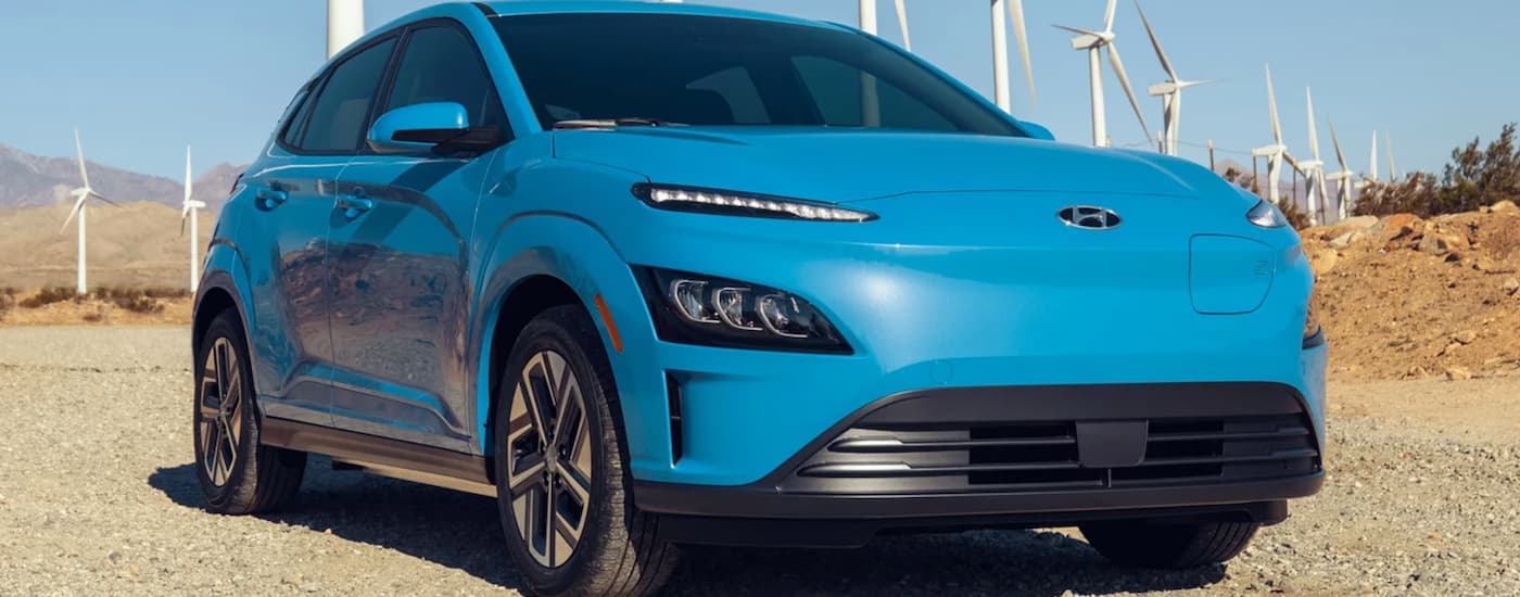 A blue 2023 Hyundai Kona Electric is shown from the front.