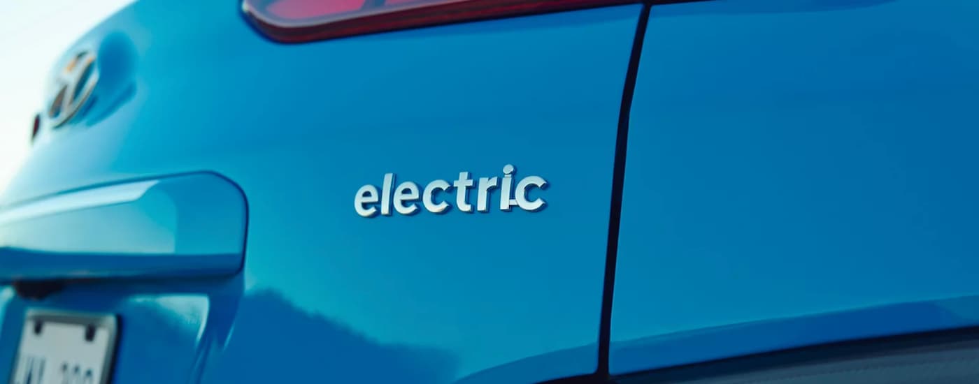 A popular Hyundai Kona Electric for sale, a blue 2023 Hyundai Kona Electric, shows the rear.
