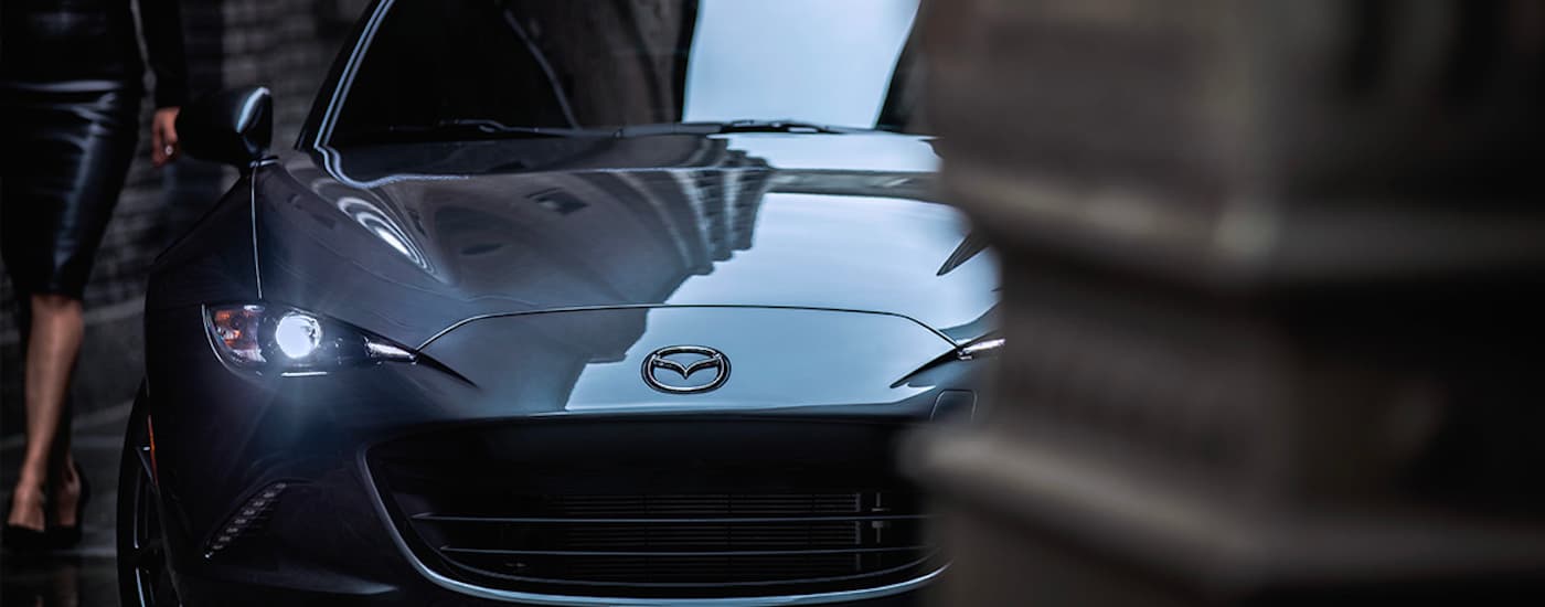 A close up shows the front of a grey 2022 Mazda MX-5 Miata RF after leaving a Edmonds Mazda dealer.