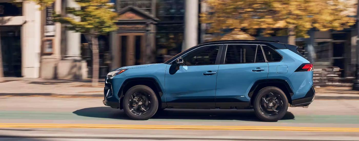 A blue 2023 Toyota RAV4 is shown from the side after leaving a Sacramento Toyota RAV4 dealer.