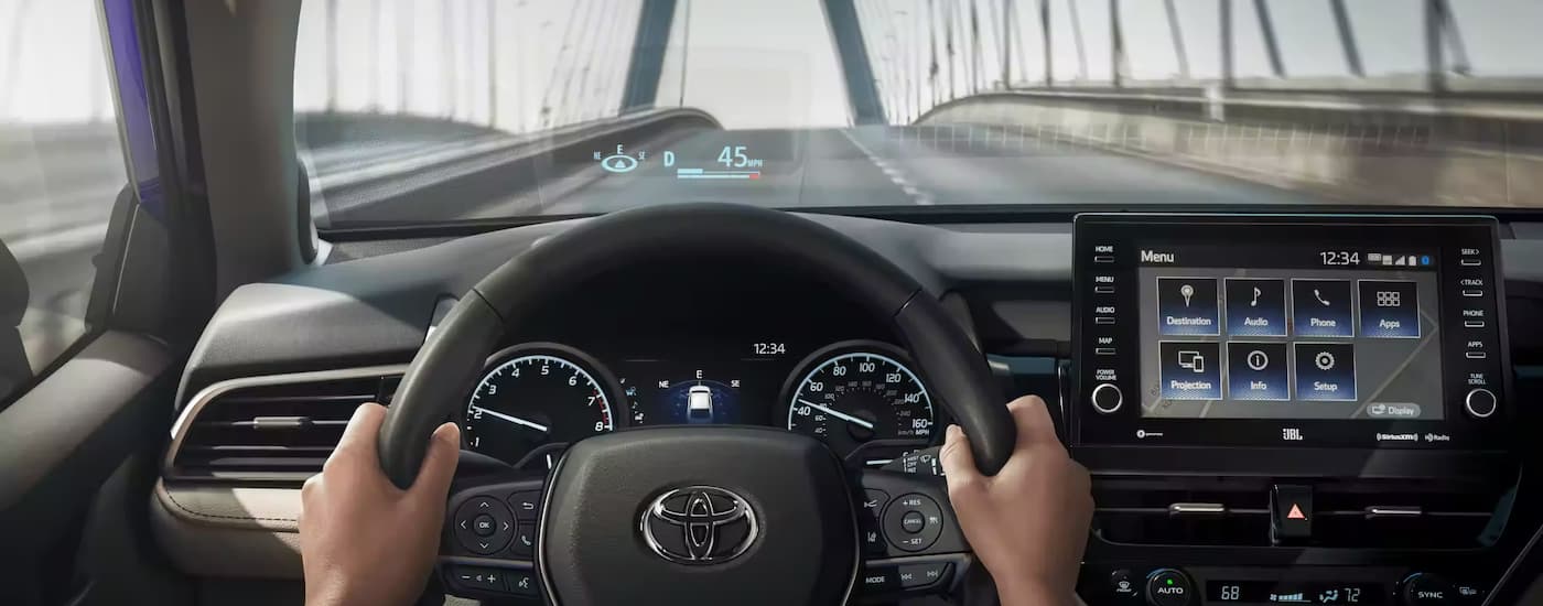 A simulation of the heads up display in a 2023 Toyota Camry, as seen from the driver's seat 