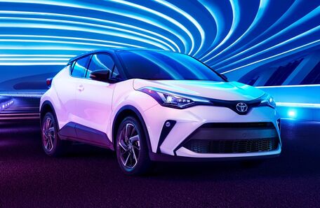 white 2021 Toyota C-HR front fascia passenger side parked in tunnel with blue lights