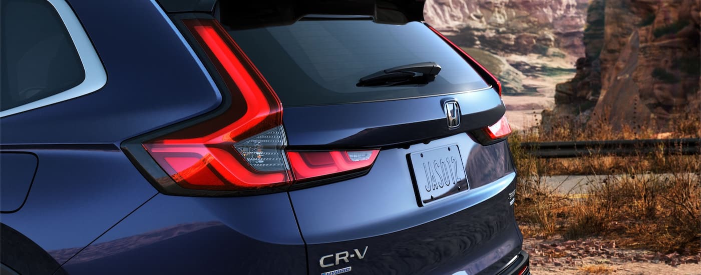 A close up of the rear liftgate on a blue 2023 Honda CR-V Sport Touring Hybrid is shown.