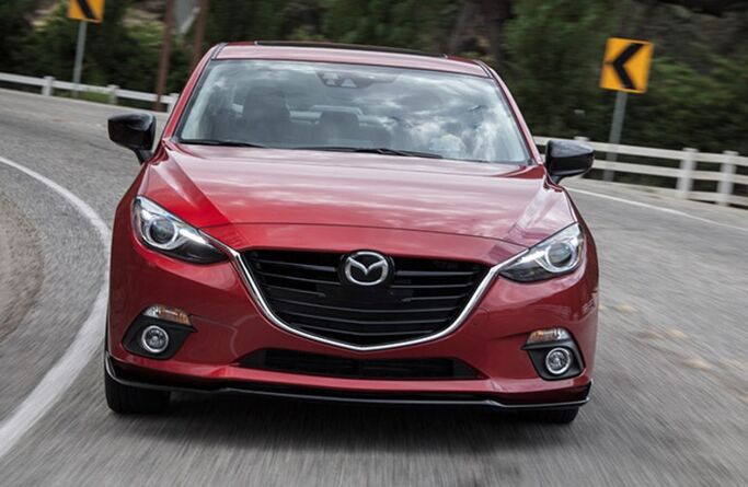 2016 Mazda3 red exterior front fascia driving around curve