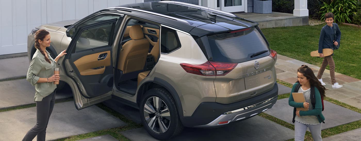 A tan 2023 Nissan Rogue is shown parked in a driveway after leaving a Nissan Rogue dealer near Roscoe, IL.
