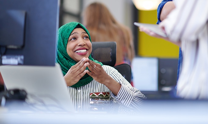 Woman in hijab working in office
