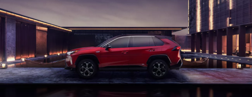 A red 2023 Toyota RAV4 Prime during the night.