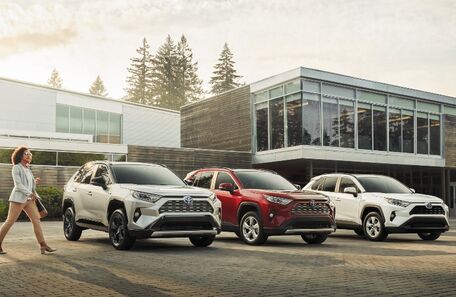 2021 Toyota RAV4 three models in front of modern building
