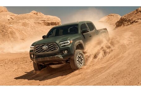 2021 Toyota Tacoma exterior green driving through dusty sand