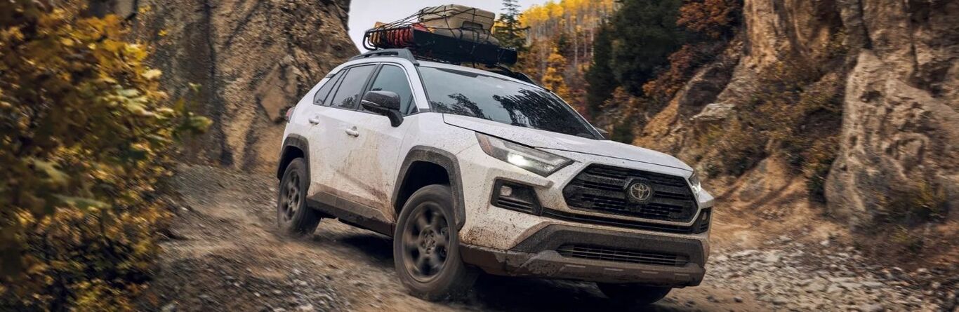 Frontview of a white 2022 Toyota RAV4 cruising down a mountain