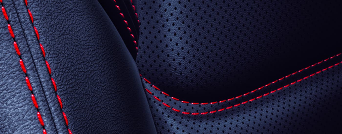 A close up shows the red stitching on the black leather seat in a 2023 Mazda CX-5.