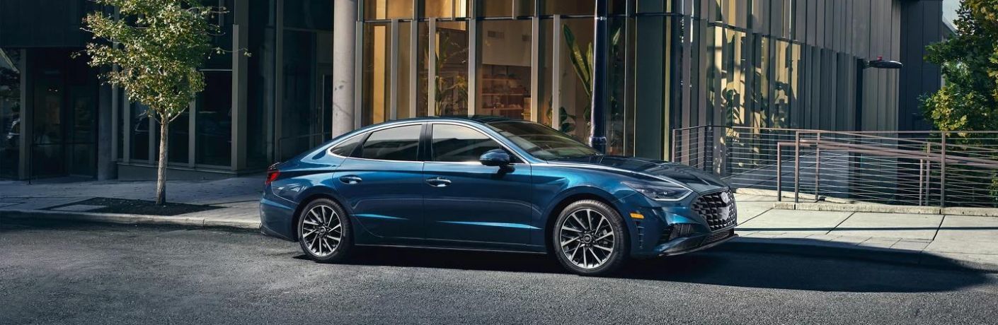 A blue 2023 Hyundai Sedan parked in the city. 