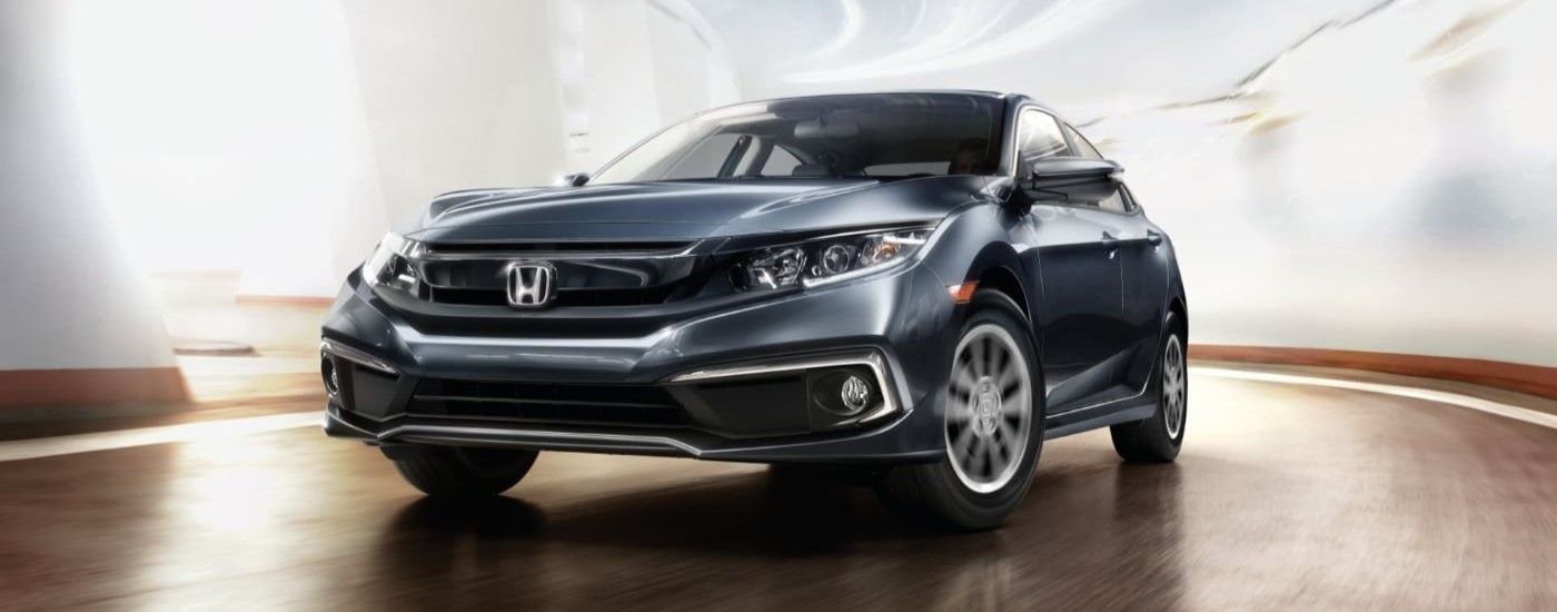 A grey 2019 Honda Civic for sale is shown rounding a corner.