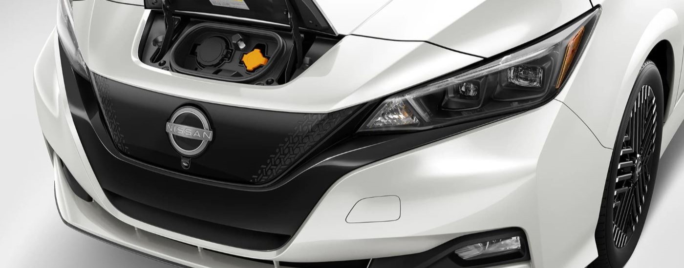 A close up shows the charge port on a white 2024 Nissan LEAF.