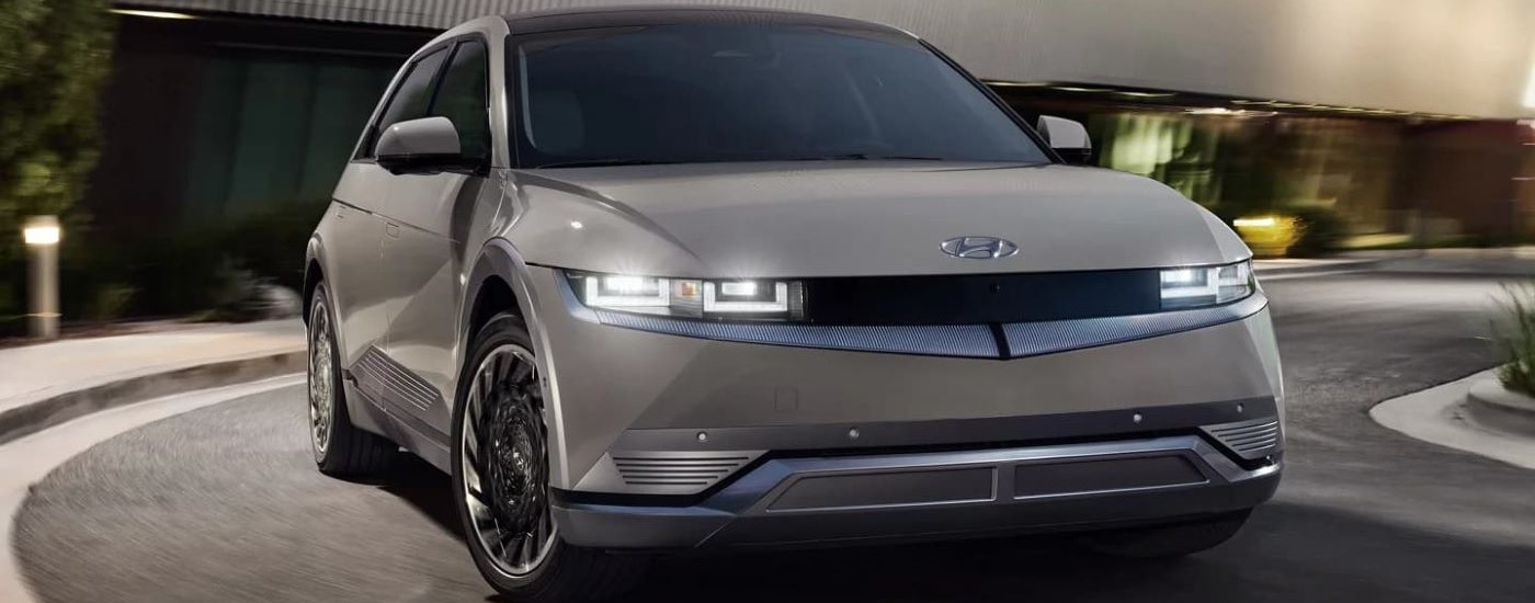 A popular Hyundai IONIQ for sale, a silver 2023 Hyundai IONIQ 5, is shown rounding a corner.