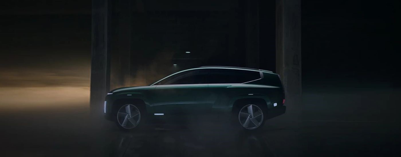 A dark green 2024 Hyundai IONIQ 7 is shown from the side.
