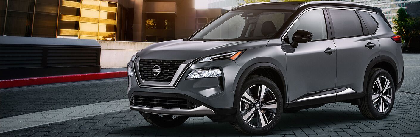 Silver 2021 Nissan Rogue by a spunky building