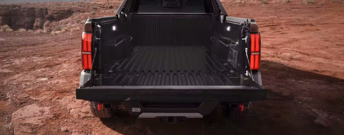 A close up shows the bed of a black 2024 Toyota Tacoma Trailhunter.