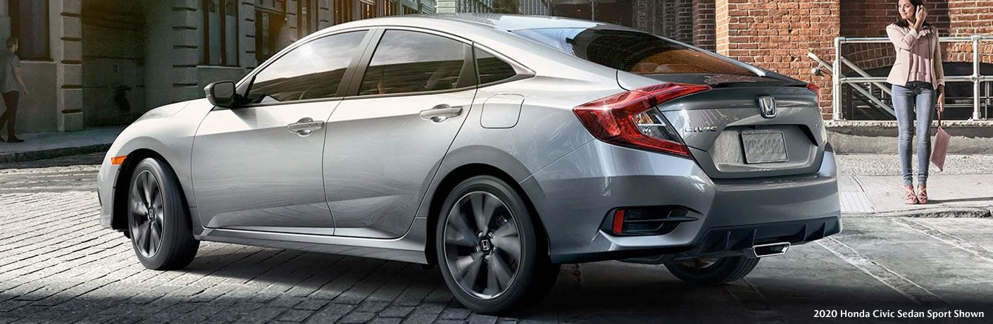 Silver 2020 Honda Civic sedan turns a corner in a city.