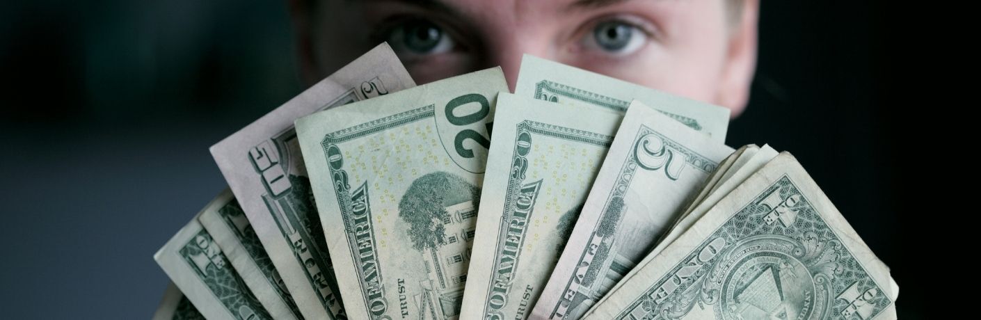 A man holding dollar bills