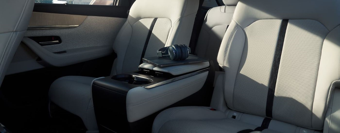 Headphones are shown on the rear armrests of a 2024 Mazda CX-90.