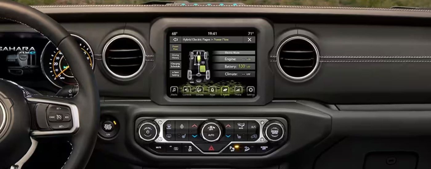 A close up shows the infotainment screen in a 2024 Jeep Wrangler 4xe Sahara.
