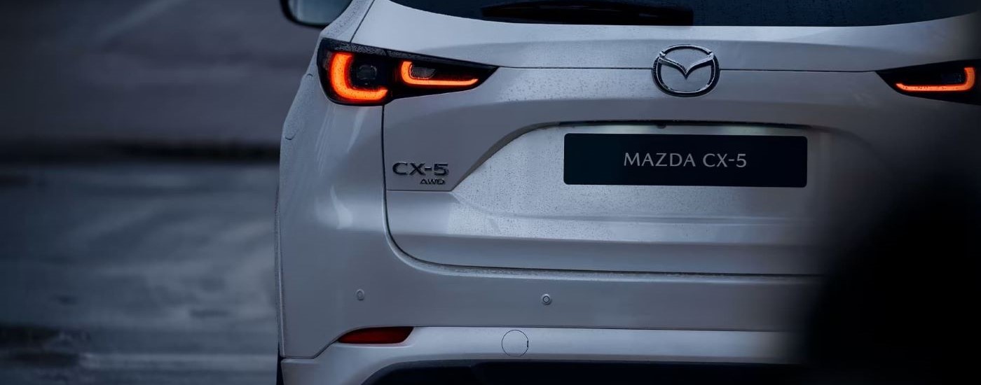 A close up shows the driver side taillight on a white 2023 Mazda CX-5.