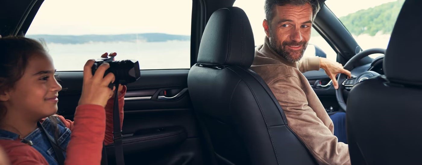People are shown taking photos in a 2023 Mazda CX-5.