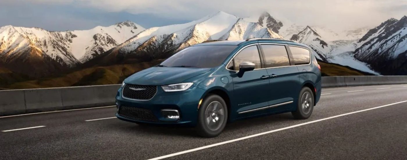A blue 2023 Chrysler Pacifica Pinnacle Hybrid is shown after looking at EVs for sale near Spruce Grove.