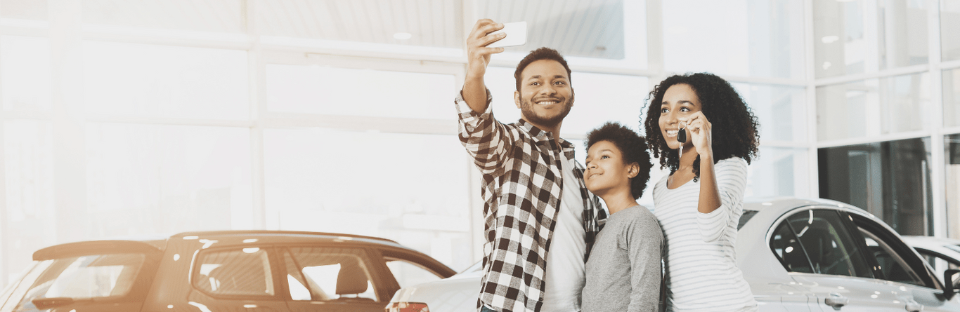 A couple taking a selfie at a dealership