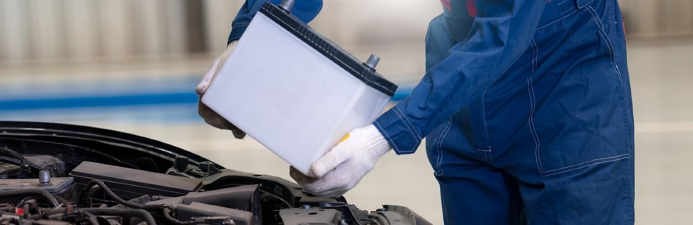 Mechanic replacing a car battery