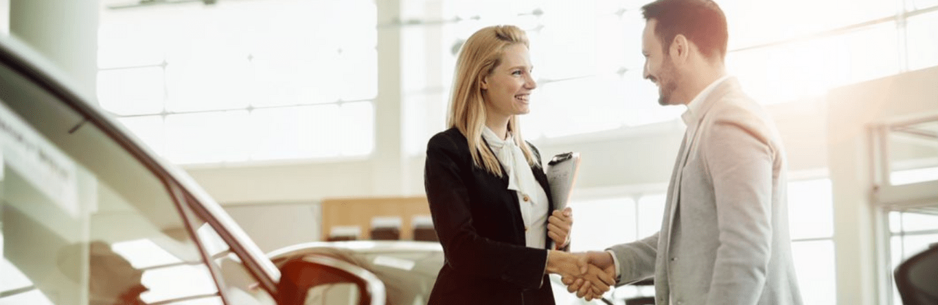 A man with an employee at the dealership