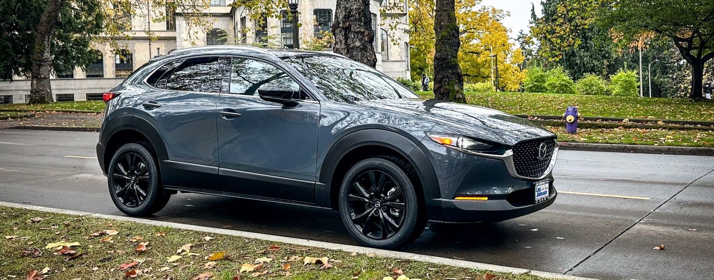A grey 2023 Mazda CX-30 for sale is shown near a fire hydrant.