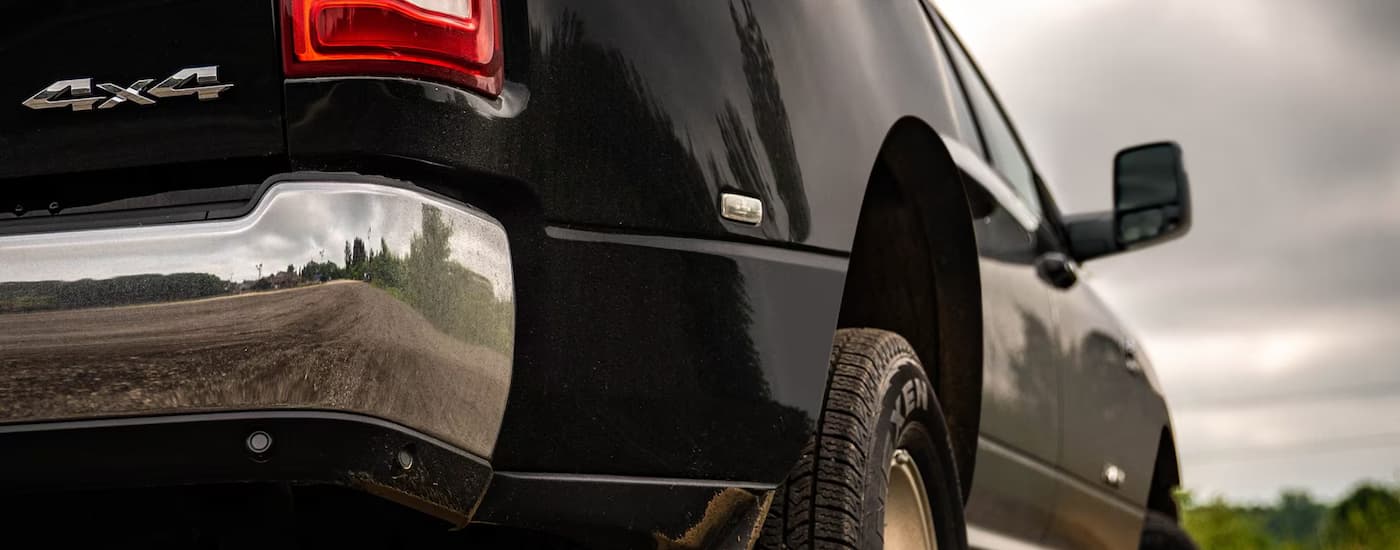 A close up of the rear bumper on a black 2023 Ram 3500 HD is shown.