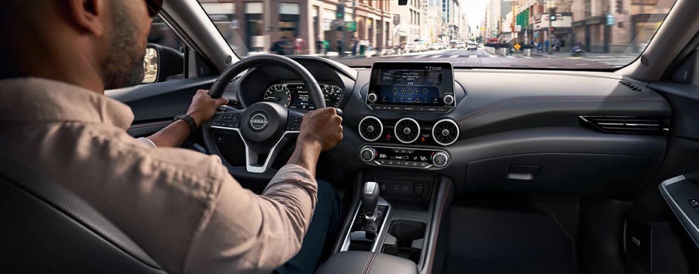 A person is shown driving a 2024 Nissan Sentra.