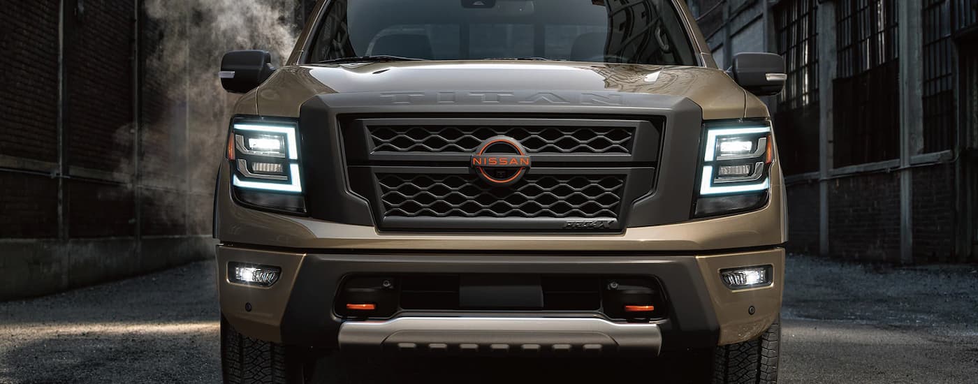 A brown 2023 Nissan Titan is shown from the front parked in an alley.