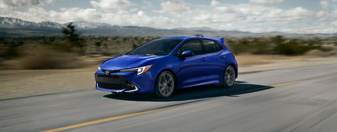 A blue 2024 Toyota Corolla is shown on an open road after leaving a Toyota dealer near you.