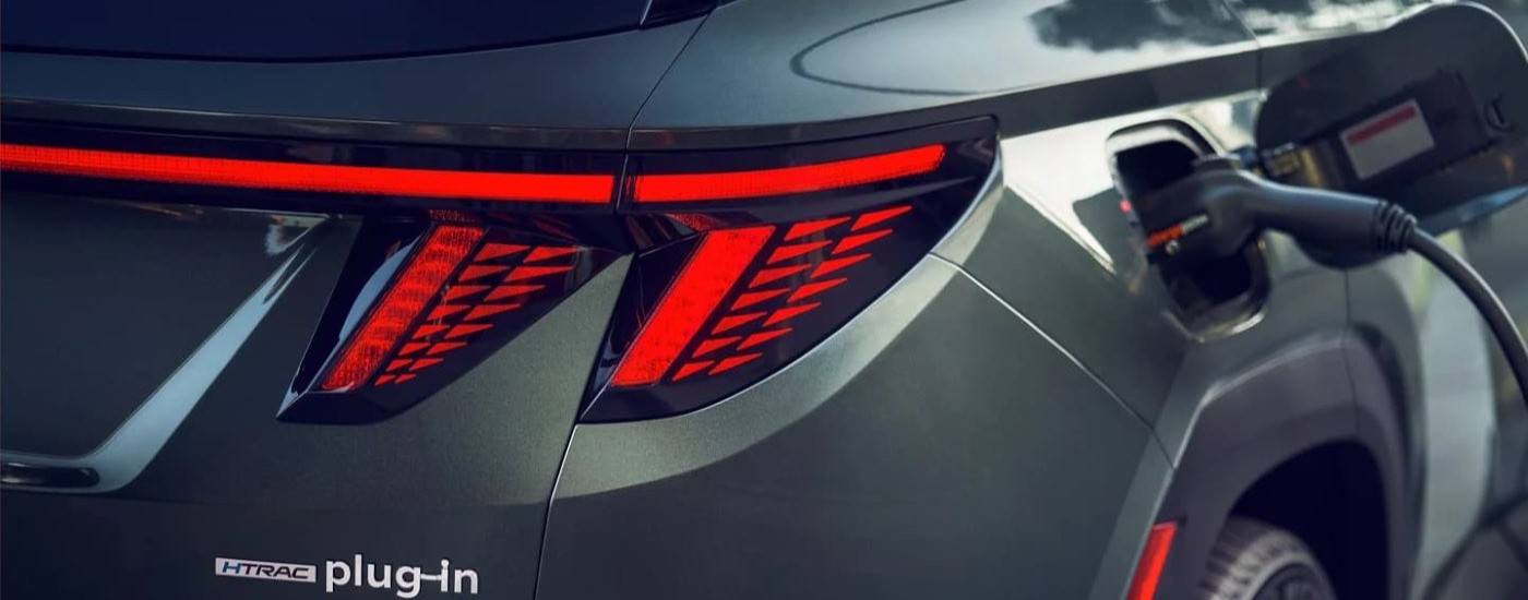 A close up of the rear bumper on a green 2023 Hyundai Tucson PHEV is shown.