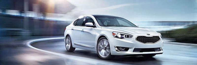 White Kia Vehicle Driving