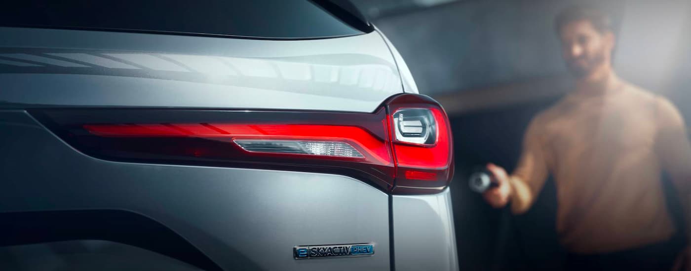A close up shows the passenger side taillight on a white 2024 Mazda CX-90 PHEV.
