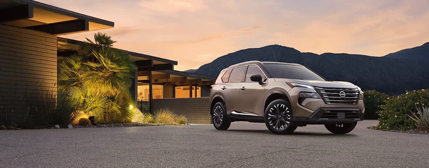 A bronze 2024 Nissan Rogue for sale is shown from the front at an angle.