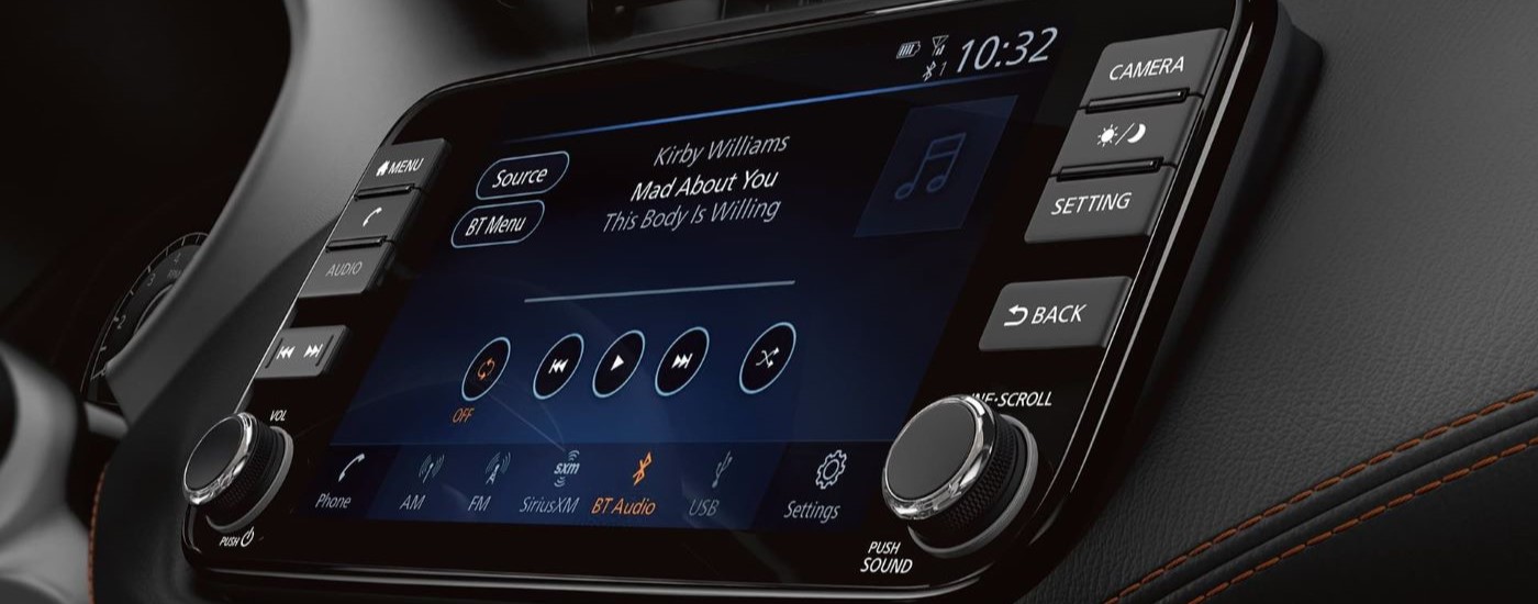 The infotainment screen is shown playing a song in a 2024 Nissan Kicks.