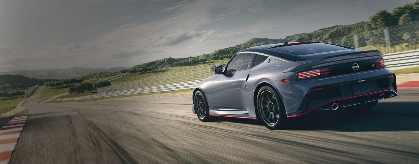 A grey 2024 Nissan Z Nismo is shown on a racetrack after leaving a Nissan dealer near St. Albert.