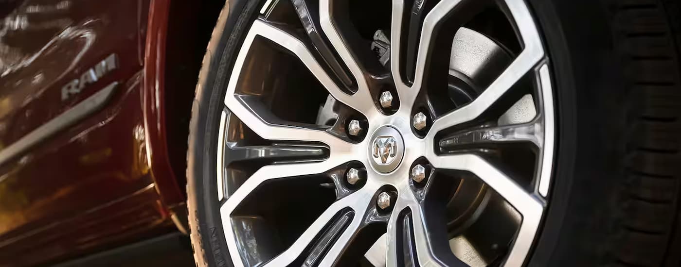 A close up of the wheel and rim on a 2025 Ram 1500 is shown at a Ram dealer near Sherwood Park.